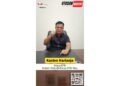Kasten Harianja Ketua DPD Ikatan Pemuda Karya IPK Riau yang duduk di belakang meja dengan ekspresi bersemangat